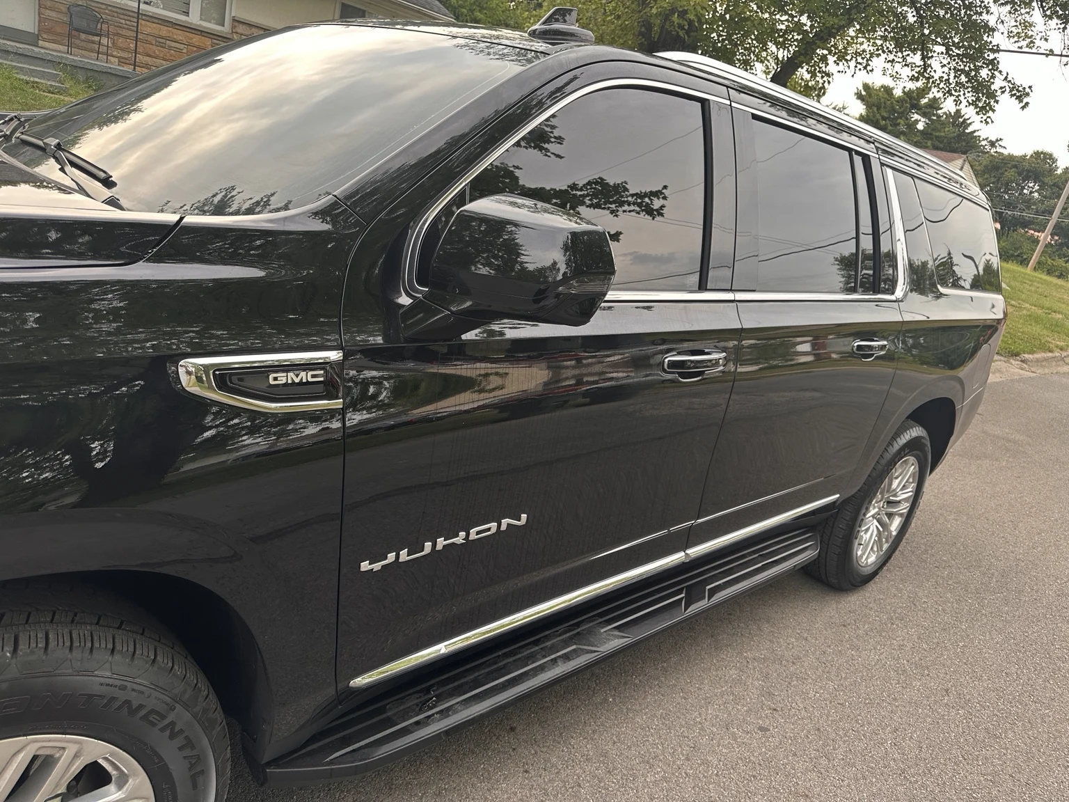 Side profile view of a tinted GMC Yukon XL